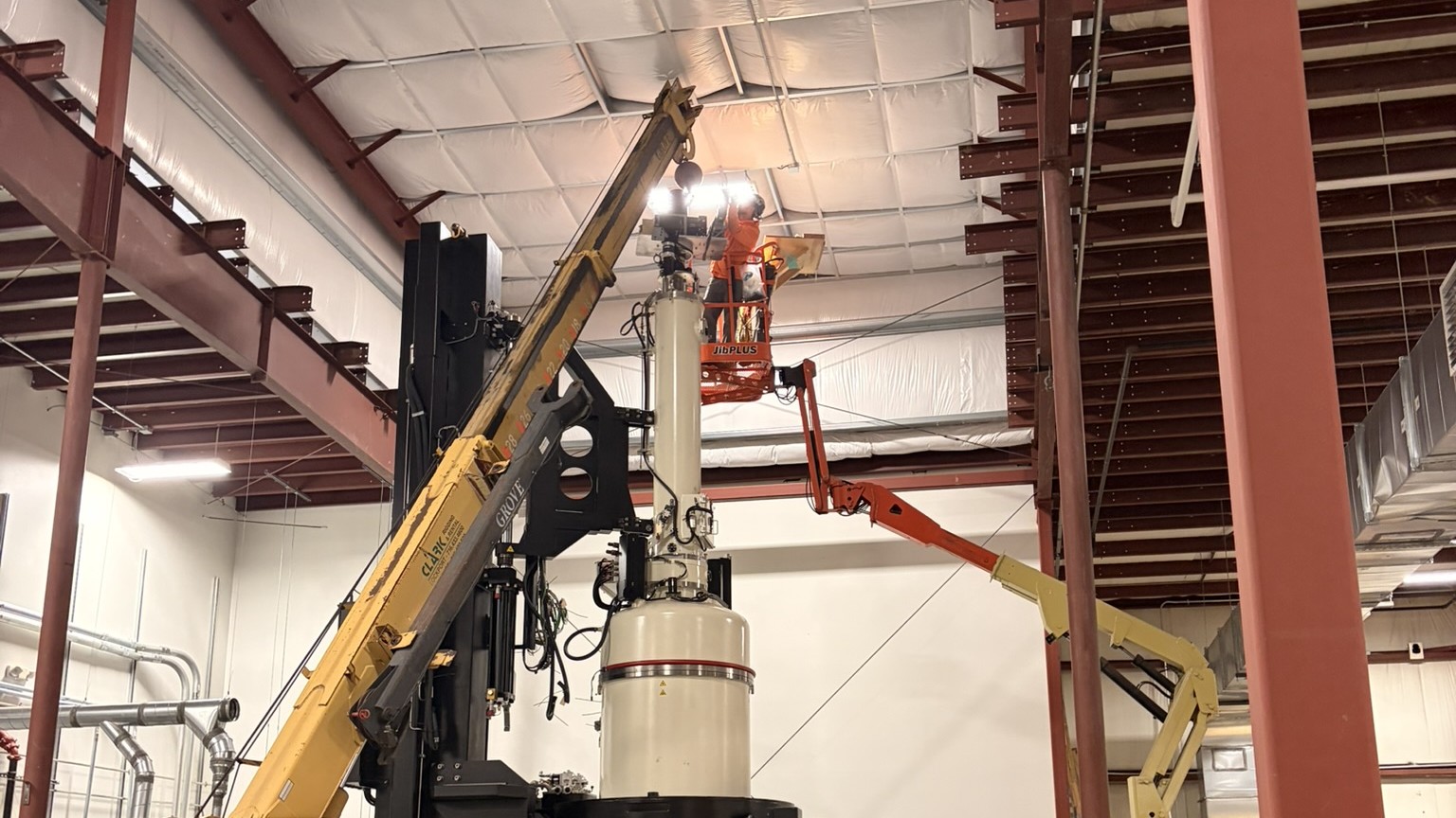 Carry deck crane lifting a CZ furnace column section during top-down deinstallation